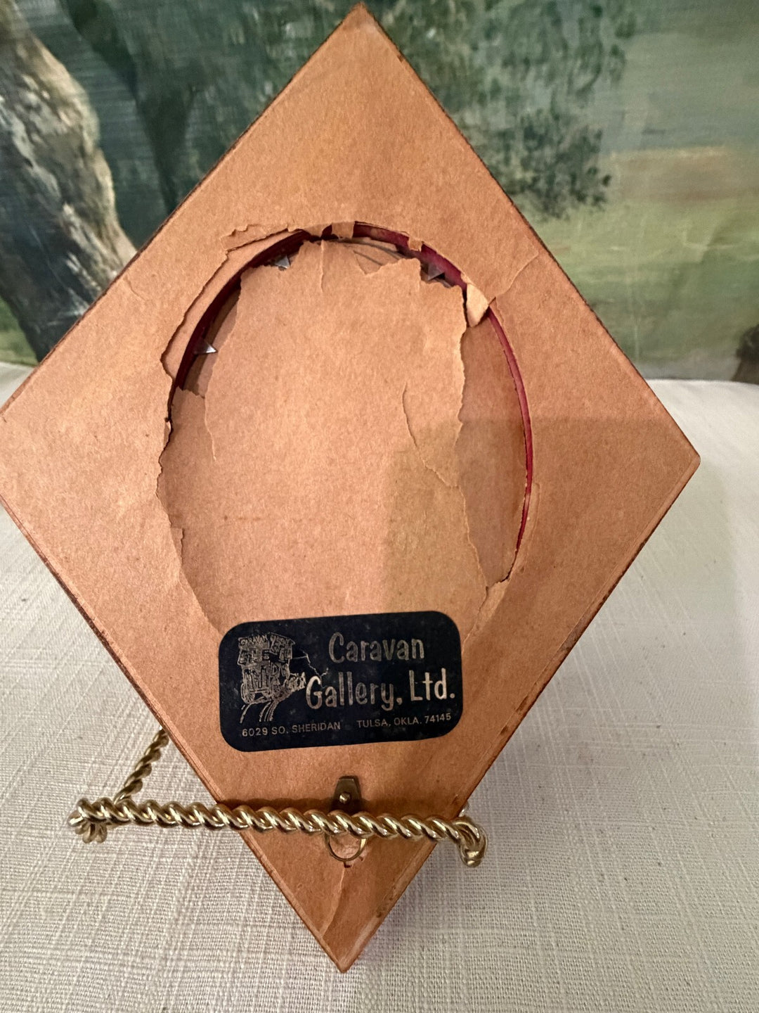 Diamond shaped wood frame with bird oval insert