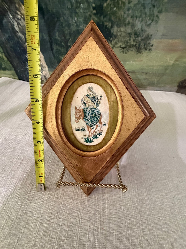 Diamond shaped wood frame with bird oval insert