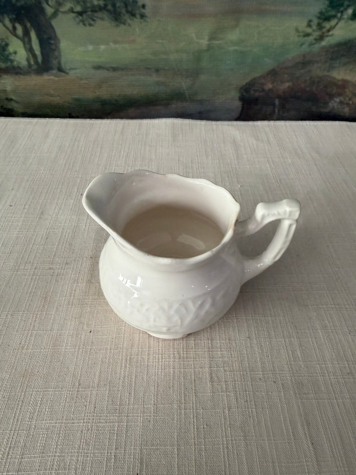 White ceramic sugar bowl and creamer set
