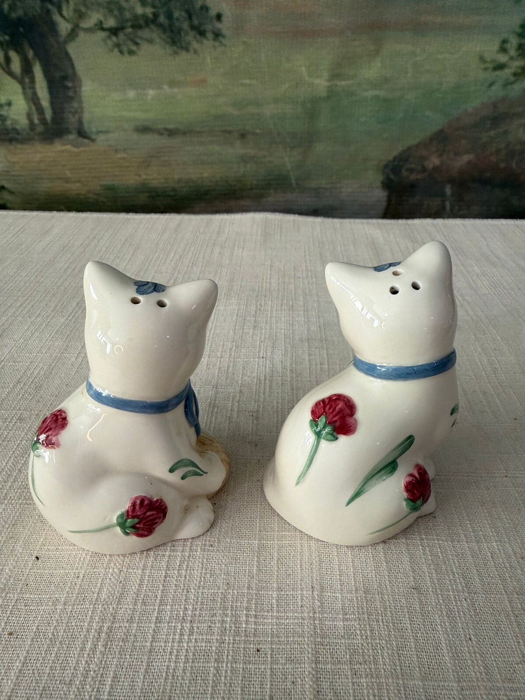Pair of White Ceramic Cat Figurines with Blue Bows and Red Flowers