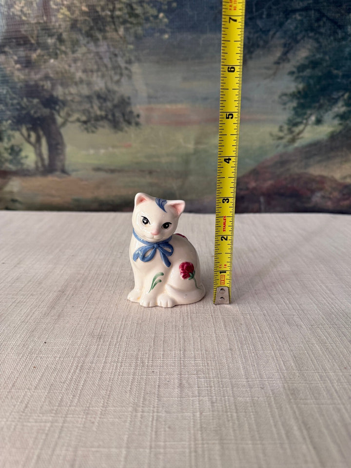 Pair of White Ceramic Cat Figurines with Blue Bows and Red Flowers